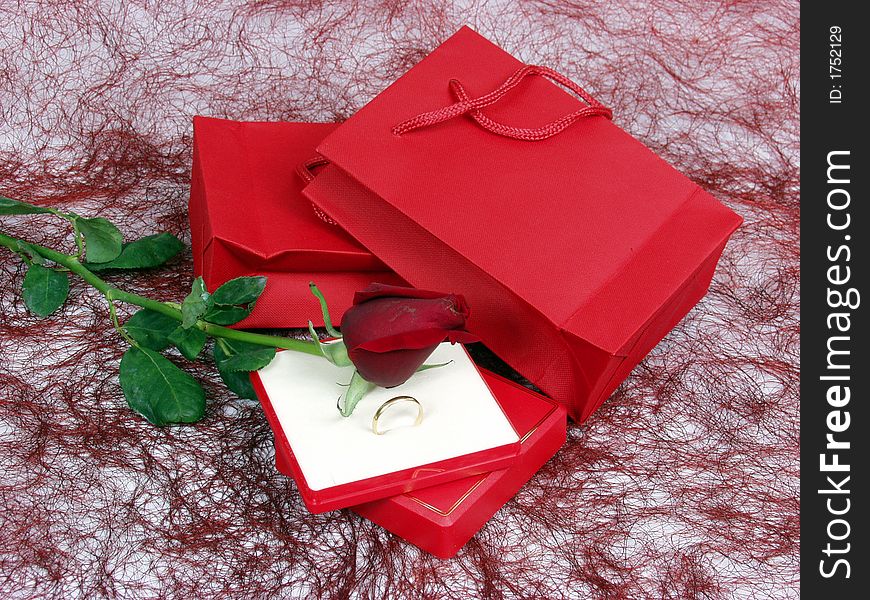 Gold ring on a gift box with red rose for valentineï¿½s day