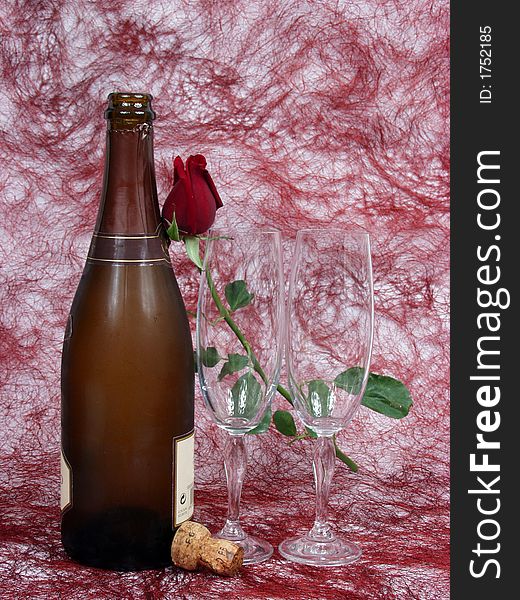 Champagne bottle, cups and red rose for valentine day