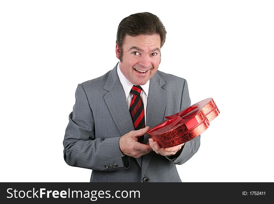 A handsome man in a suit surprised by Valentines candy. Isolated on white. A handsome man in a suit surprised by Valentines candy. Isolated on white.