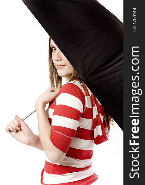 Woman looks back at the camera from an umbrella. Woman looks back at the camera from an umbrella