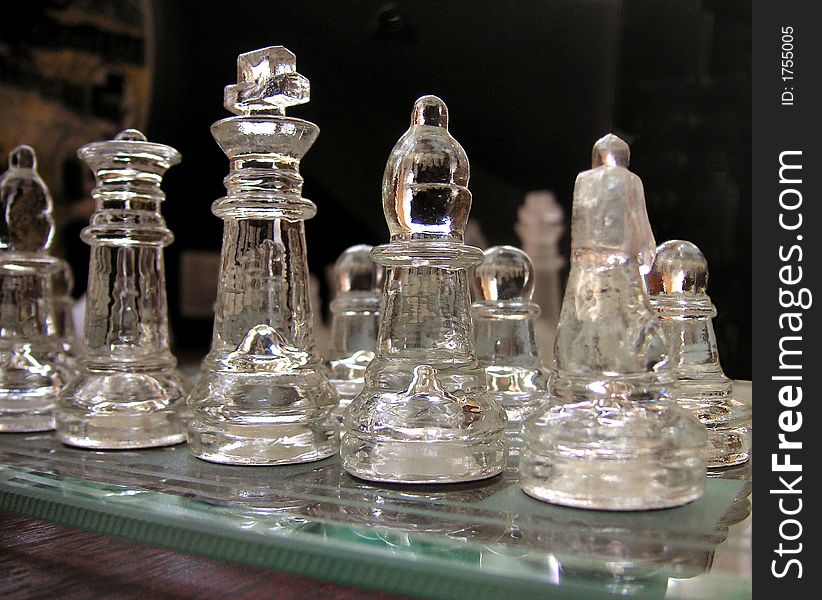 Glass chess set up for a game