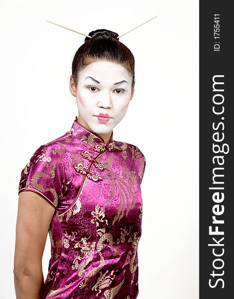 Lady with geisha makeup and chinese cheongsam dress. White background.