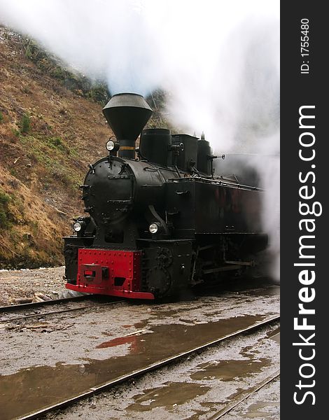 Steam railway vintage locomotive through the mountains