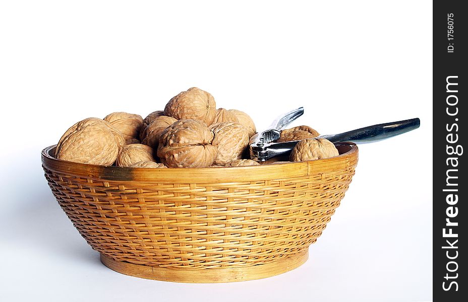 Walnuts and nutcracker in a bowl. Walnuts and nutcracker in a bowl