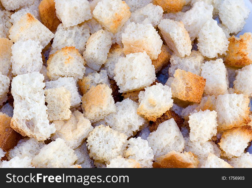 Bread croutons seen as a macro close-up background. Bread croutons seen as a macro close-up background