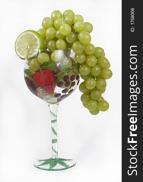 Grapes, kiwi and lime in a fancy glass. Grapes, kiwi and lime in a fancy glass