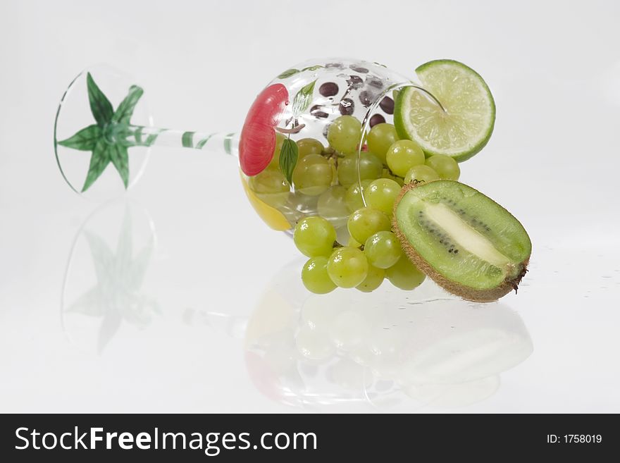 Kiwi, grapes and lime in a fancy glass. Kiwi, grapes and lime in a fancy glass