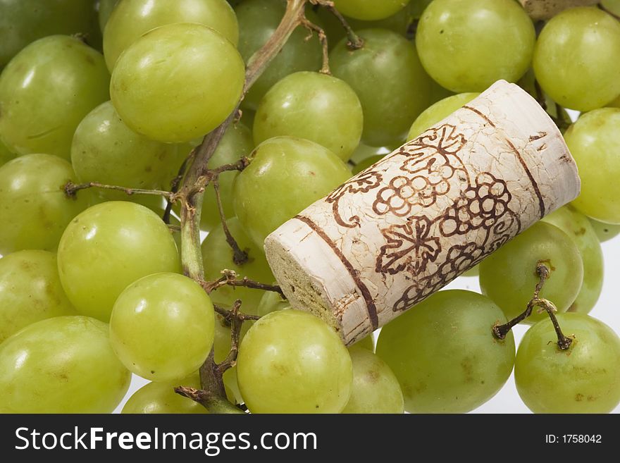 Grapes and a wine cork over white. Grapes and a wine cork over white