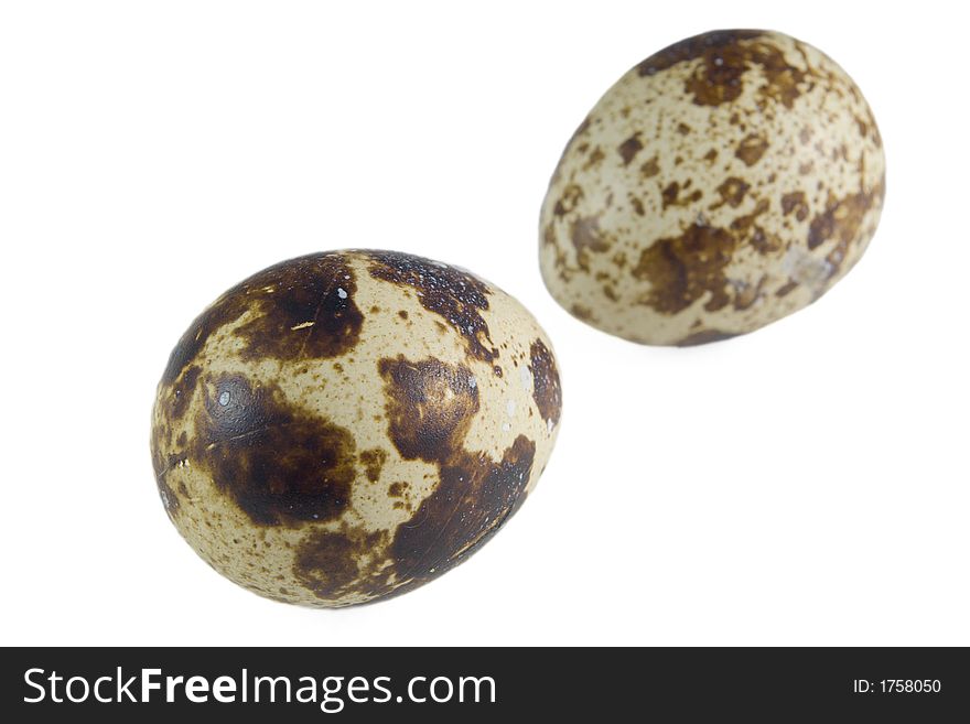 Pair of quail eggs on the white