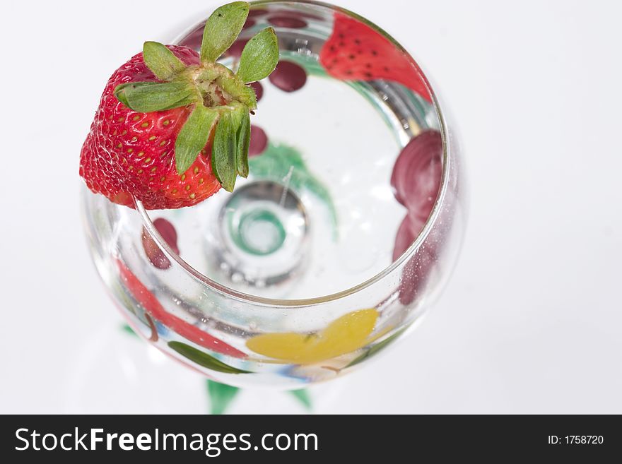 A glass and strawberry, close up. A glass and strawberry, close up