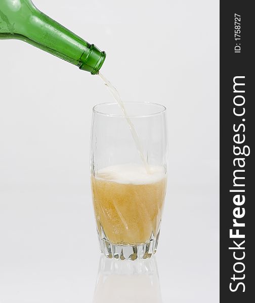 Beer pouring into glass on a white background