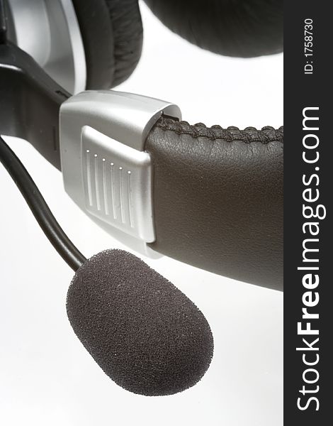 Headphones with a speakerphone over white background. Headphones with a speakerphone over white background