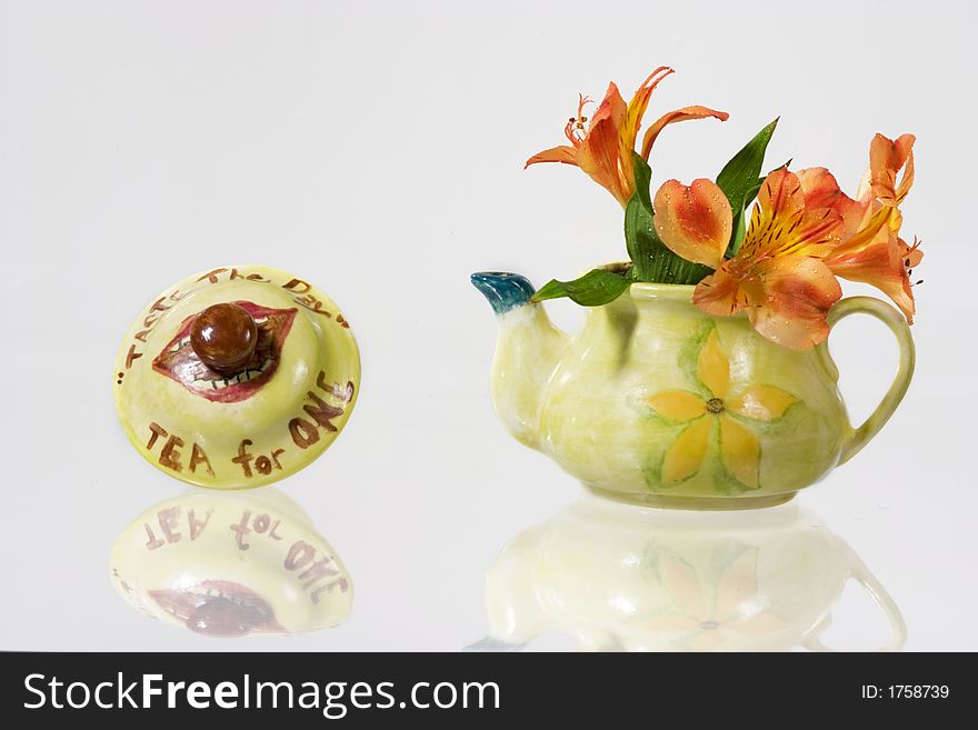 Green fancy kettle with flowers over white background