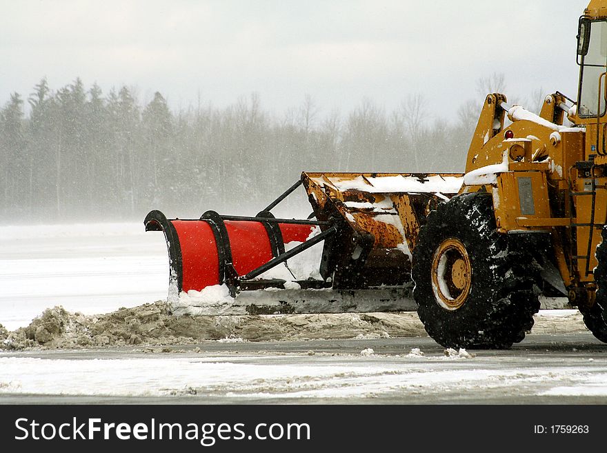 Snow plow clearing snow at airport after a winter storm. Snow plow clearing snow at airport after a winter storm