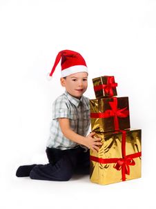 Boy In Santa Hat With A Bunch Of Gifts Stock Images Boy In Santa Hat With A Bunch Of Gifts Stock Images