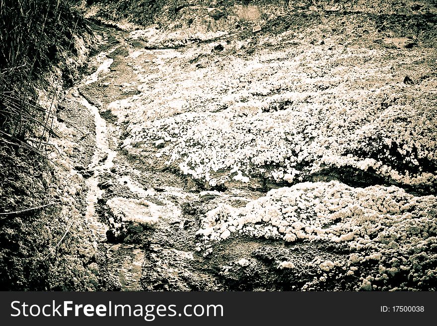 The bed of a dried-up creek covered with salt