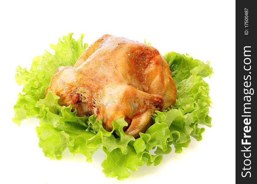 Roast chicken on leaves salad on a white background is isolated. Roast chicken on leaves salad on a white background is isolated.