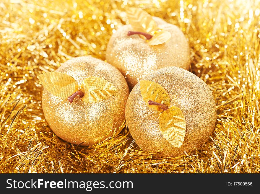 Golden apples lying on the golden background