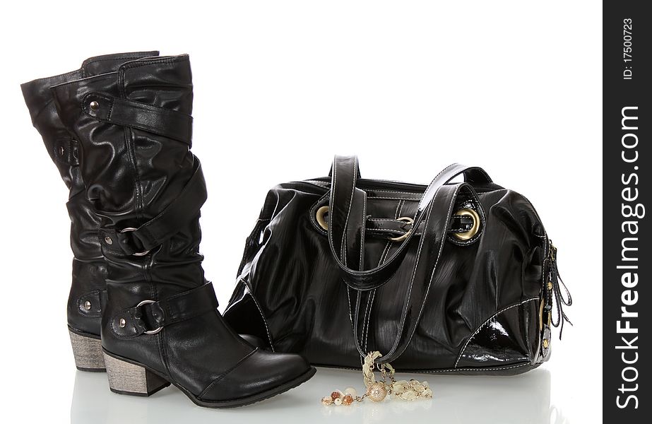Black female boots and bag on a white background it is isolated. Black female boots and bag on a white background it is isolated.