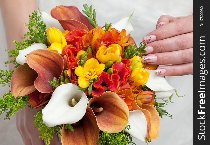 Close-up of colorful wedding bouquet at bride's hands