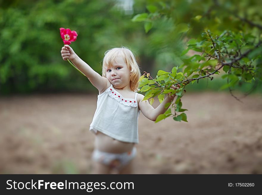 Happy Small Girl With Tulip