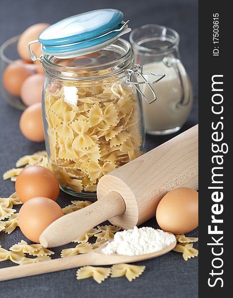 Glass jar and pasta on dark background