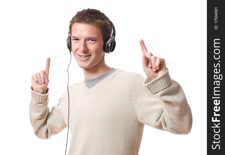 Youg man listening music with headphones isolated over white background