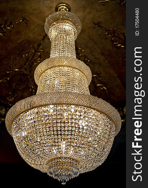 Isolated golden crystal chandelier indoors