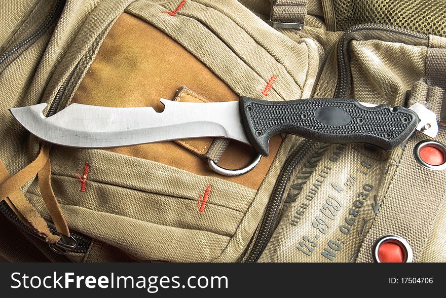 Army knife on a marching backpack background. Army knife on a marching backpack background