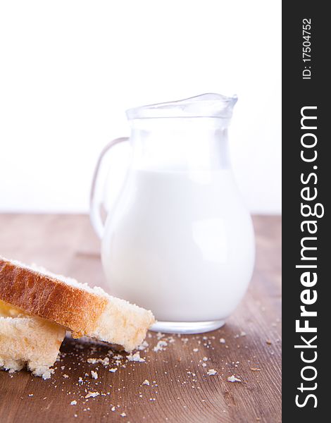 Fresh cooking bread with jug of milk. Fresh cooking bread with jug of milk