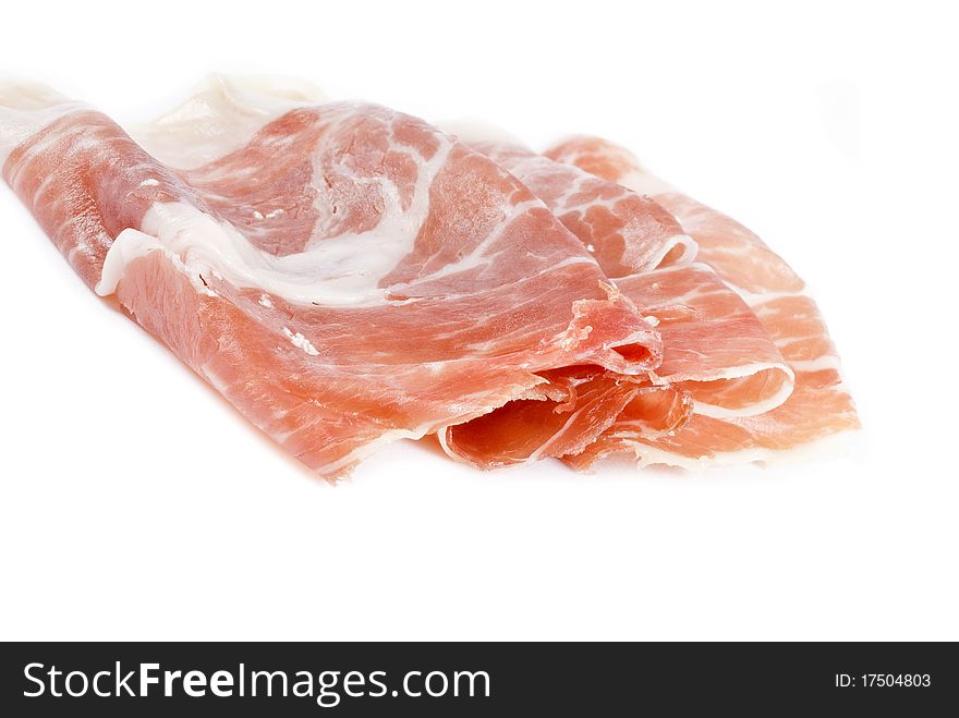 Slices of Iberico Ham isolated on white. Slices of Iberico Ham isolated on white.