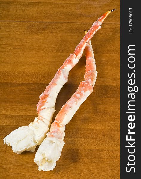 Pre-cooked frozen Alaskan King Crab legs on a table.