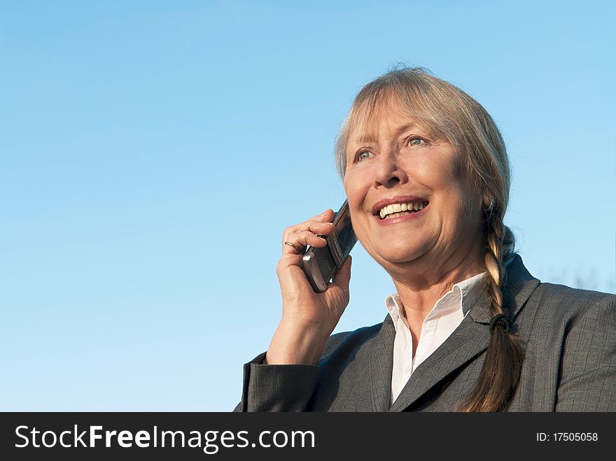 Happy Mature Businesswoman Using Cellphone.