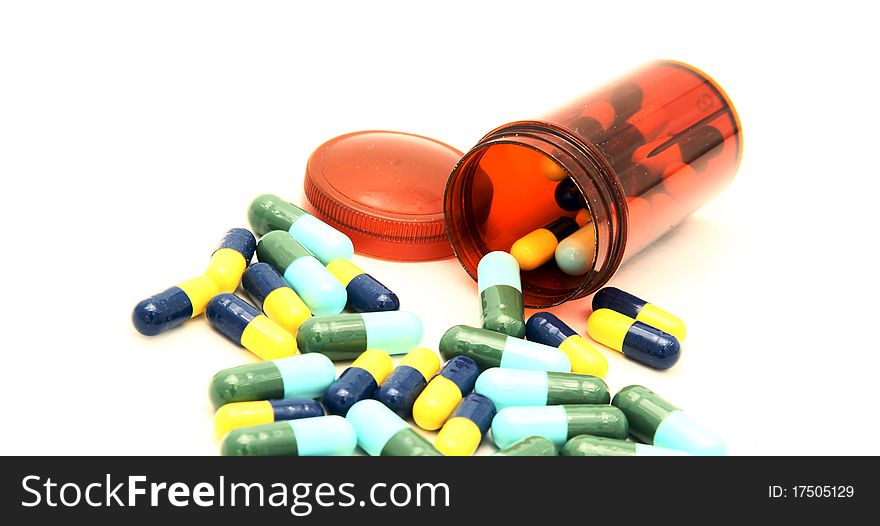 Colorful capsule spilling out from pill box