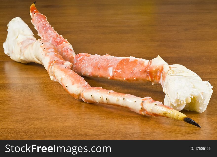 Pre-cooked frozen Alaskan King Crab legs on a table.