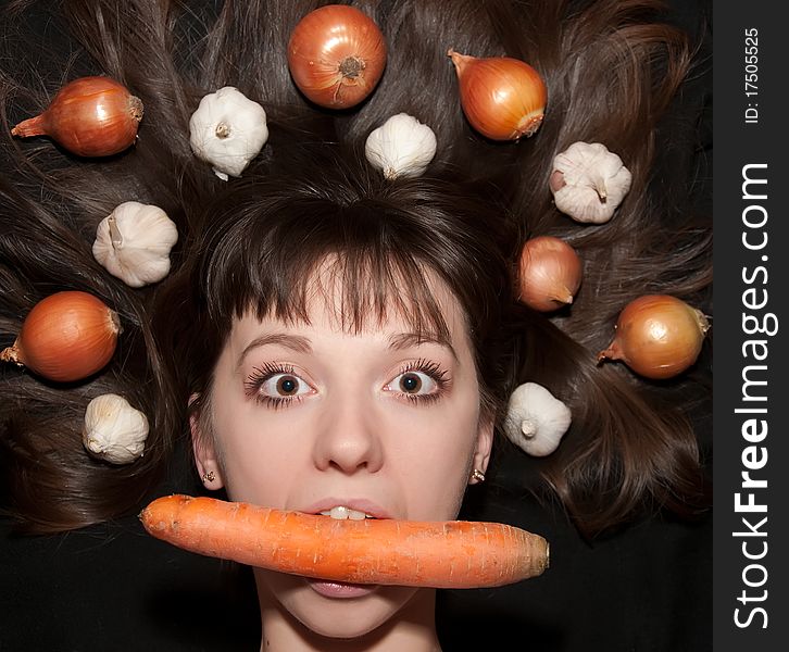 Portrait of a girl with vegetables in her hair