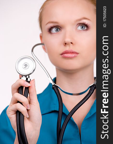 Young female doctor listening a heartbeat by stethoscope