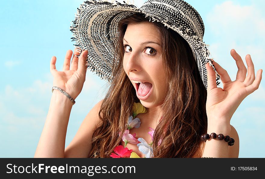 Sexy brunette beach girl standing on the beach wearing a sun hat