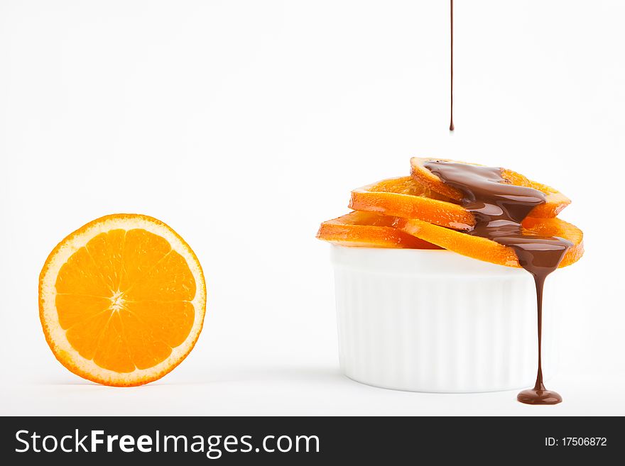 Ripe oranges with chocolate on a white background