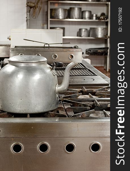 Restaurant kitchen with a kettle in the foreground