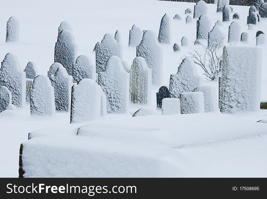 An old graveyard after a snow storm. An old graveyard after a snow storm