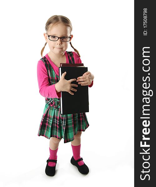 Cute preschool age girl wearing eyeglasses carrying a stack of heavy books. Cute preschool age girl wearing eyeglasses carrying a stack of heavy books