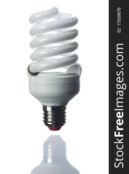 Compact fluorescent light bulb isolated over white background. Small reflection of the bottom.