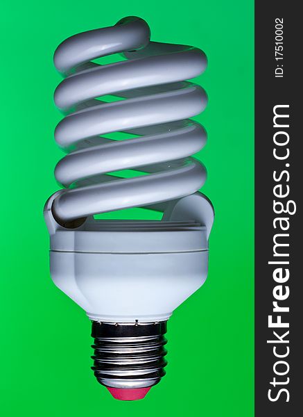 Energy saving lamp on the green background