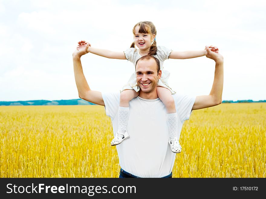 Happy young father and his daughter having fun at the wheat field. Happy young father and his daughter having fun at the wheat field