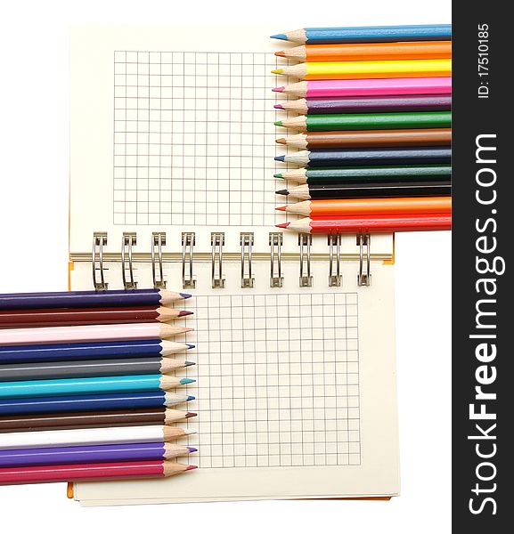 Blank notebook and color pencils isolated on white