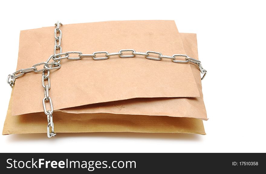 Parcel wrapped in a chain on white