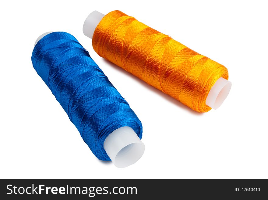 Blue and yellow spools on a white background