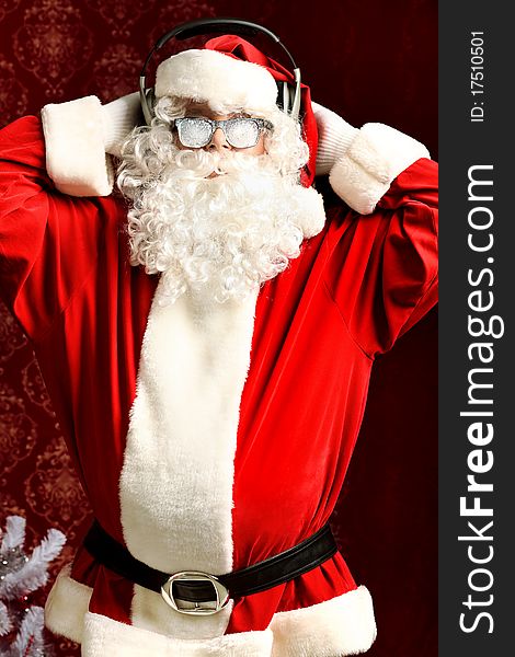 Santa Claus is listening to music in headphones. Christmas. Santa Claus is listening to music in headphones. Christmas.