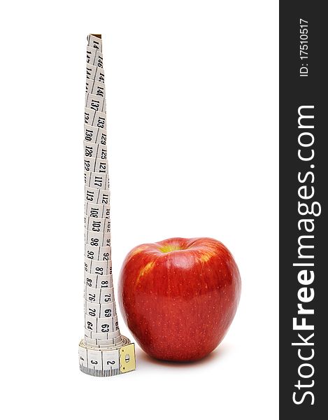 Red apple and tape measure on white